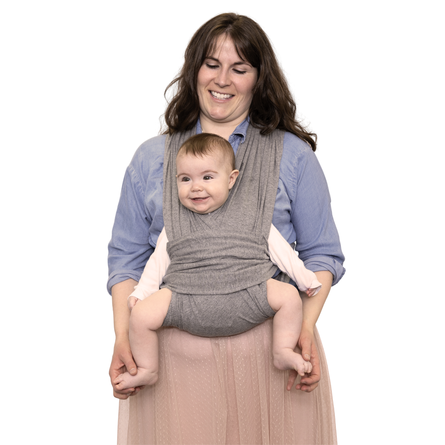 Woman holding a baby in a gray baby carrier against a white background