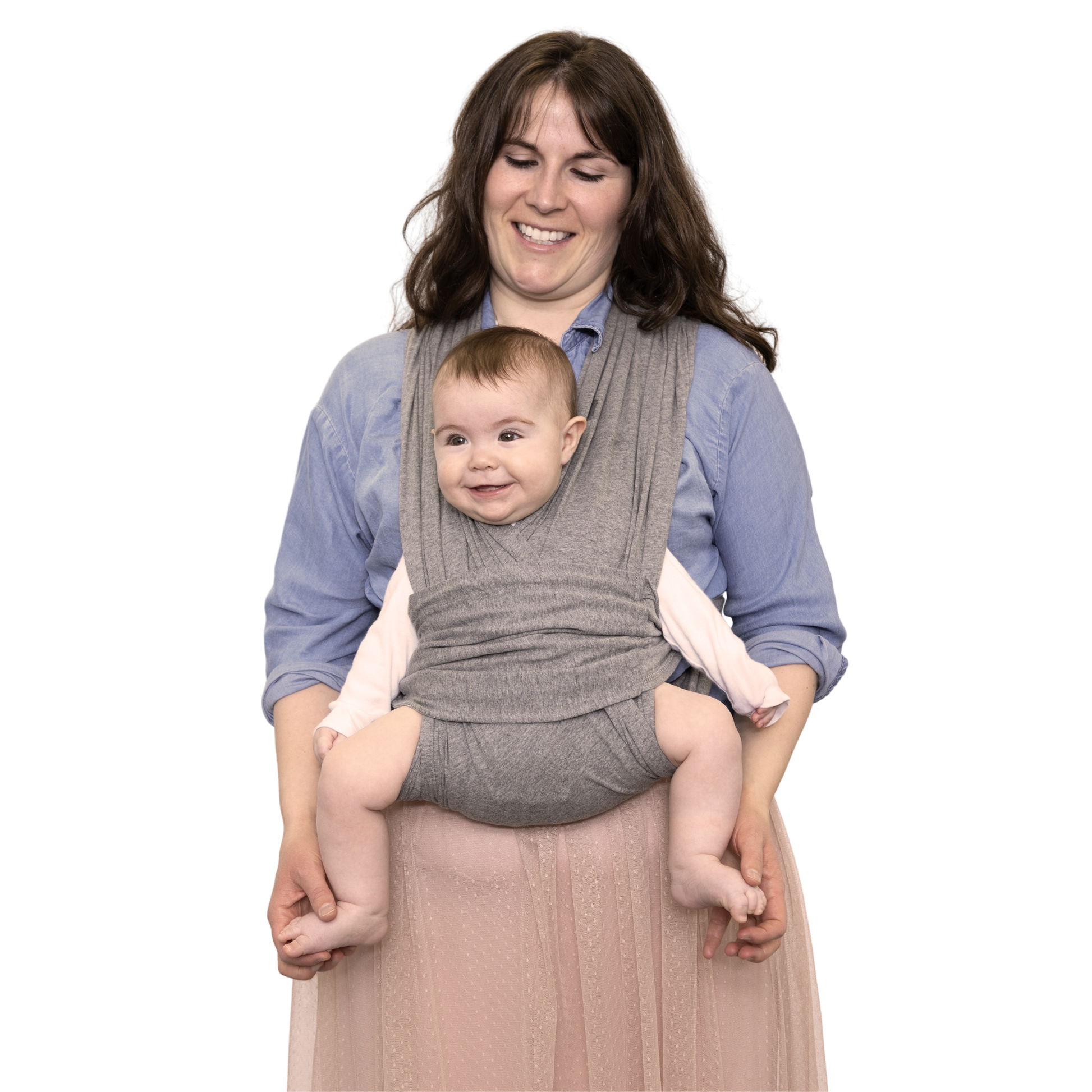 Woman holding a baby in a gray baby carrier against a white background
