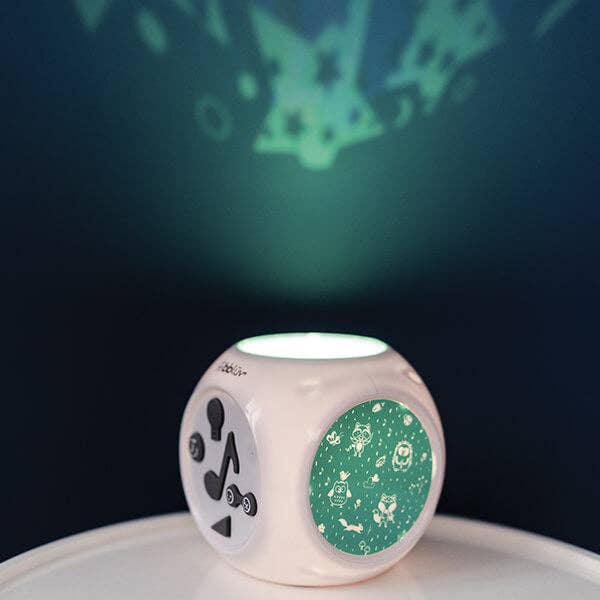 Dice-shaped night light with patterns on a dark background