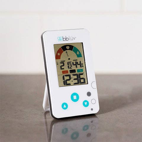 Digital thermometer with a white base on a reflective surface