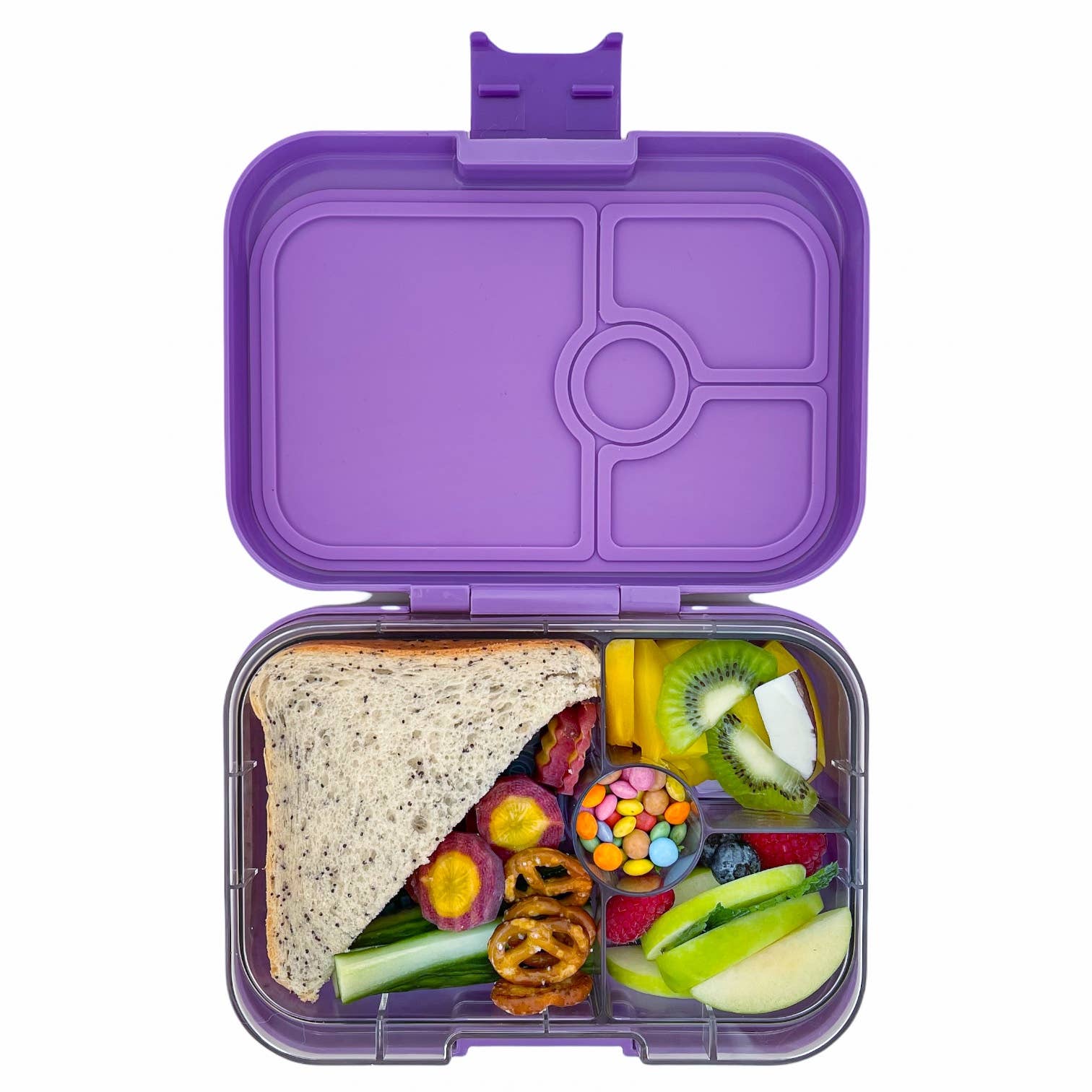 Purple Yumbox lunch box filled with food on a white background