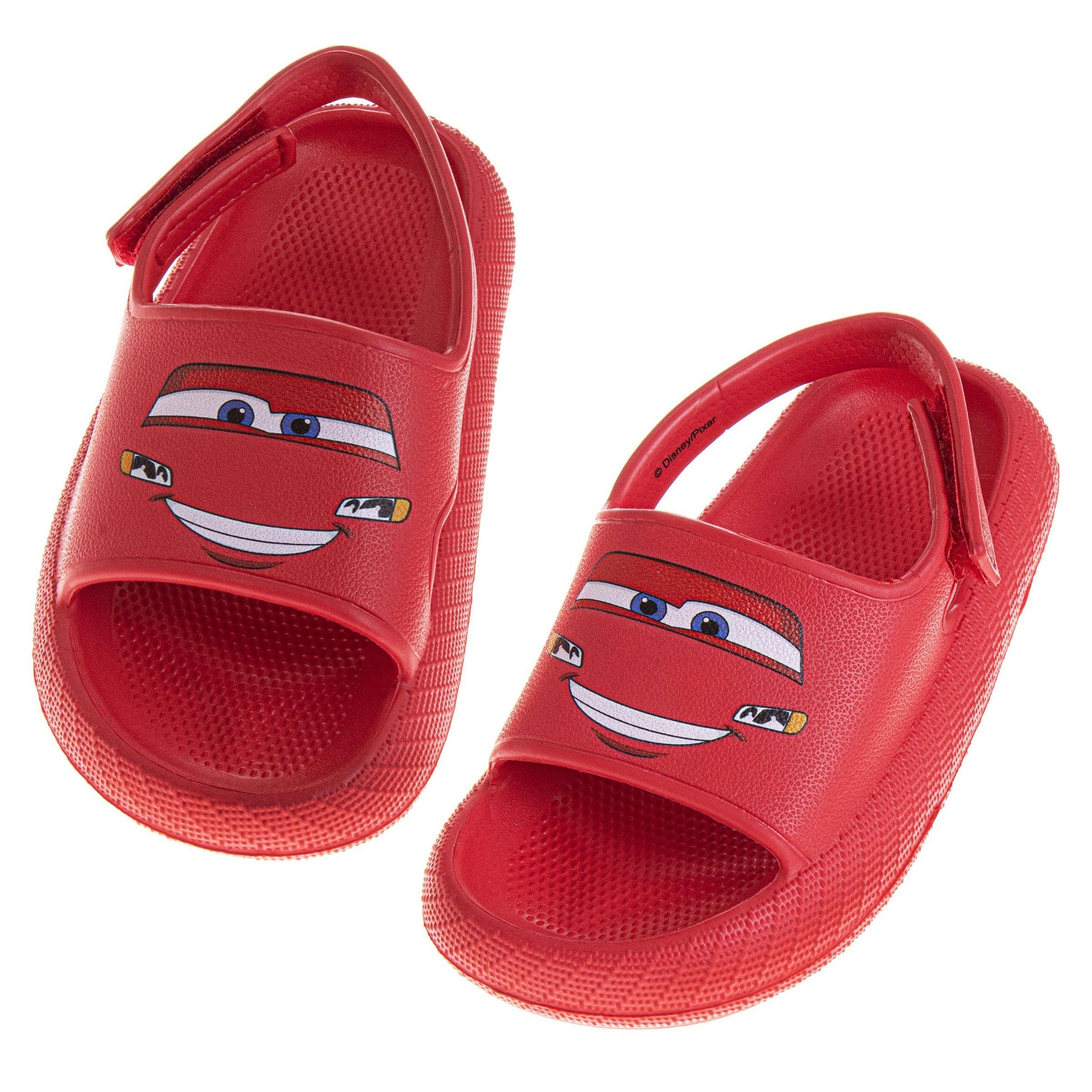 Red children's sandals with a cartoon face design on a white background
