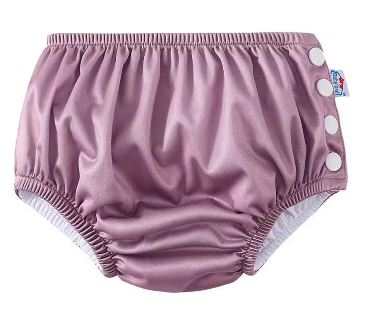 Pink baby bloomers with white buttons on a white background