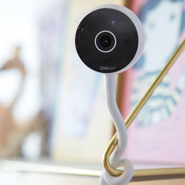 Smart home security camera with a flexible arm on a blurred background