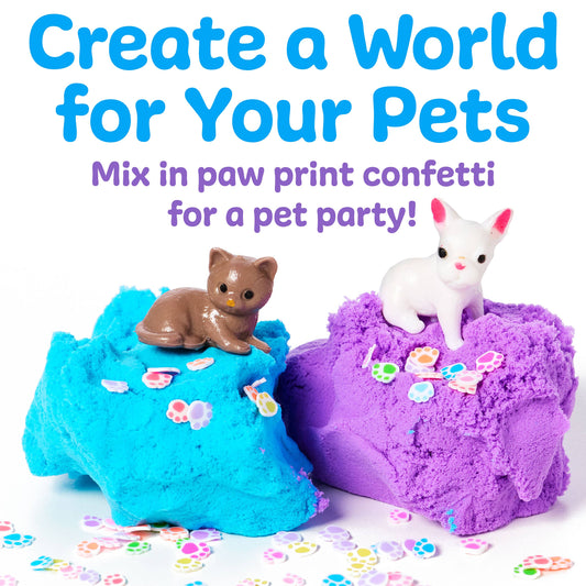 Two colorful playdough balls, one blue and one purple, with cat figurines on top, surrounded by paw print confetti.