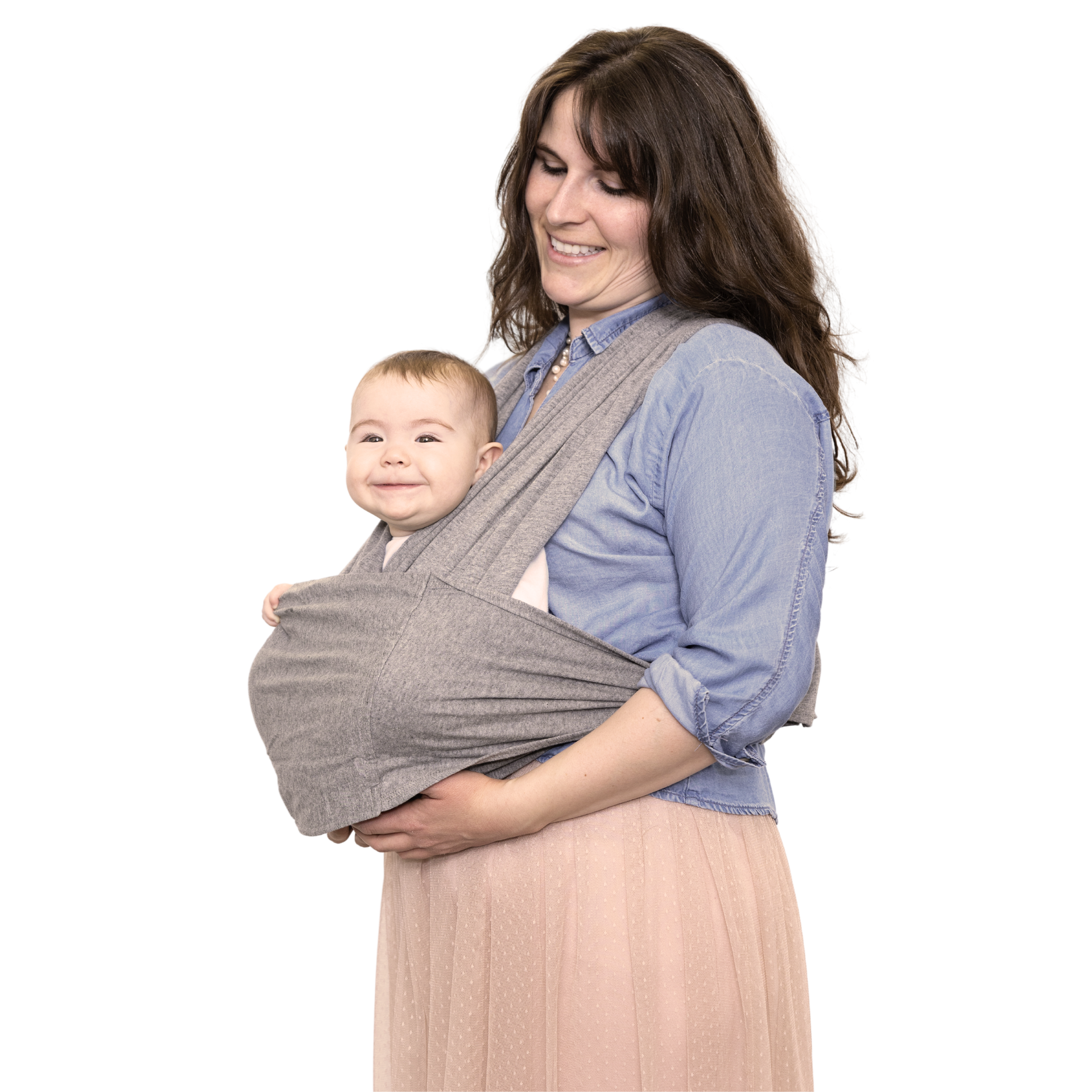 Woman holding a baby in a gray sling against a white background